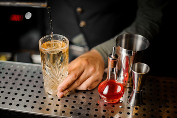 Bartender making a fresh cocktail at the bar counter