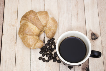 Black coffee in a glass on a wooden table