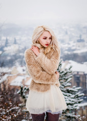 A sexy girl stands on a hill