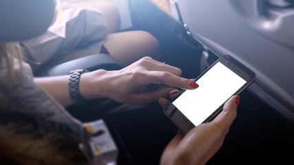 touching and slide mobile phone screen on airplane or aircraft,blank mobile phone screen mock up,selective focus