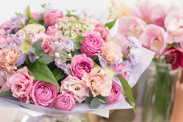 Close-up beautiful luxury bouquet of mixed flowers in glass vases. the work of the florist at a flower shop. Wallpaper