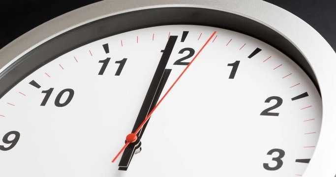 modern alarm clock is showing midday or midnight movement. It is twelve o'clock, holiday happy new year festive and christmas or lunch concept, time-lapse effect