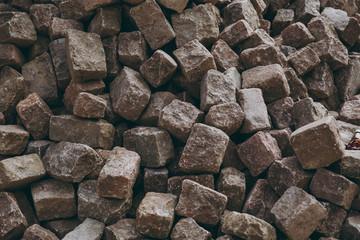Texture backdrop background pile, wall of stone, bricks, cobblestones of brown and gray colors, rectangular, parallelepiped forms