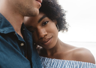 A young couple posing for portraits by the water