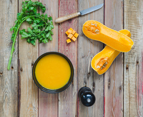 Pumpkin soup on wooden background. Top view.
