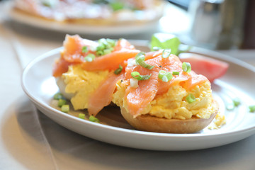 Fototapeta na wymiar Scrambled eggs with smoked salmon on toast , Breakfast food