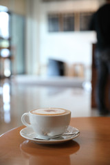 cappuccino or Latte art coffee made from milk on the wood table in coffee shop