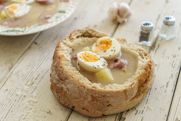 Traditional polish soup called Zurek served in small bread