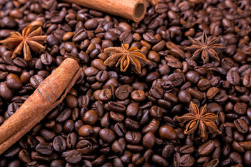 Coffee beans and cinnamon on a background of burlap. ,