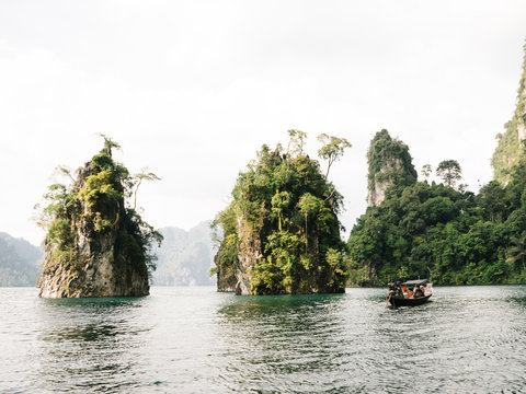 Boat Sailing Among Rocks