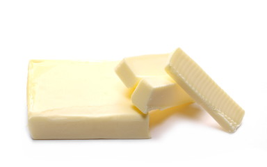 Stick of butter, cut, isolated on white background