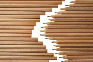 Bunch of identical graphite pencils on white background