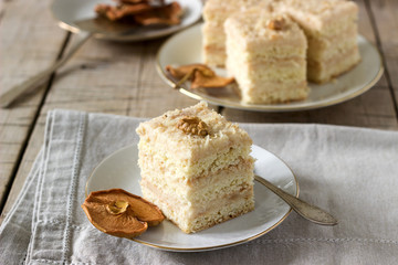 Pieces of apple cake and dried apples on a wooden table. Rustic style.