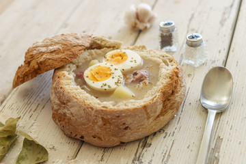 Traditional polish soup called Zurek served in small bread
