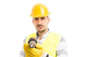 Attractive young builder or constructor holding drilling machine.