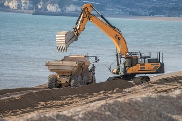 Construction Site - Engineering - Sea Defence. Large plant machinery being use to build the beach sea defence at Seaford, East Sussex, UK