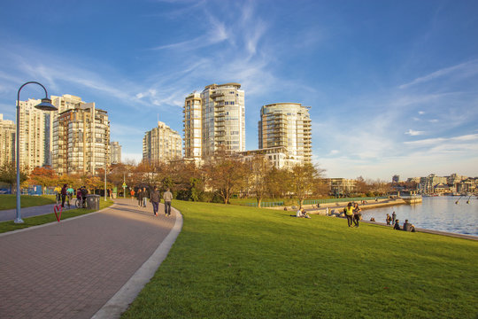 People On A Sunny Day In Downtown Vancouver Park By The Ocean