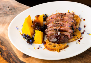 Duck breasts with sour plum - mango sauce, sweet potatoes and lotus