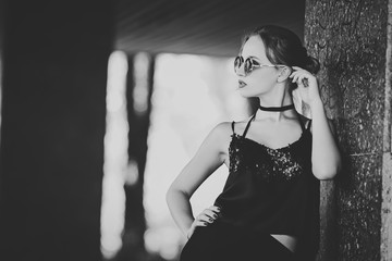 Beautiful girl model in the sun-protection glasses. Monochrome frame.