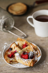 Pancakes (crepes) on a wooden surface