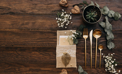 Wedding concept. Rustic table set over wooden background. Boho style, top view, flat lay