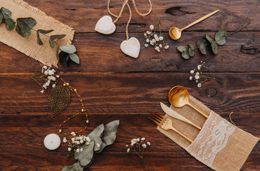 Wedding concept. Rustic table set over wooden background. Boho style, top view, flat lay