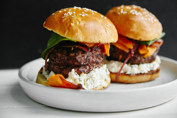 Burgers with grilled beef patties, cream cheese and spinach on classical bun.