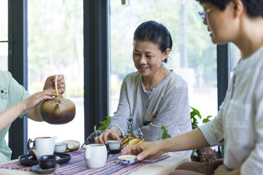 Happy Senior Asian Women Drinking Tea Together