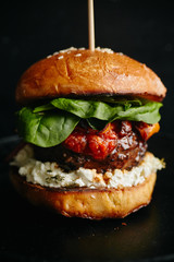 Burgers with grilled beef patties, cream cheese and spinach on classical bun.
