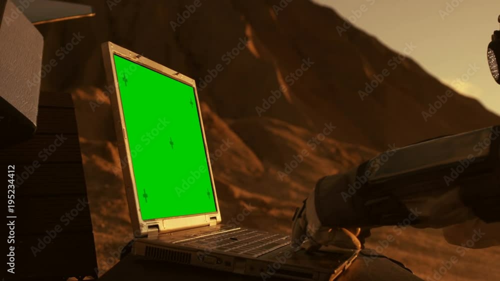 Wall mural astronaut on the alien red planet/ mars works on a mock-up green screen laptop. space exploration, f