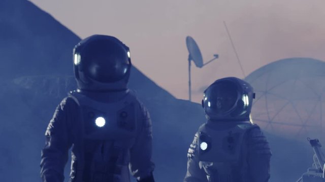 Male and Female Astronauts wearing Space Suits Explore Violet Alien Planet. Futuristic Space Exploration, Discovery and Colonization. Beautiful, Hypnotic Footage. 