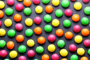 Colorful sweet candies on a grey