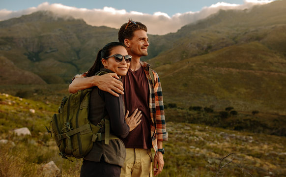 Loving Young Couple On Hiking Trip In Nature