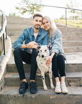 Couple with dog on stairs
