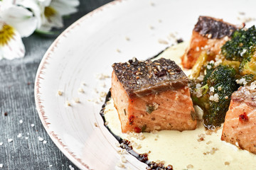 Baked fish Salmon in saffron sauce with broccoli. Dietary menu. Fish menu. Seafood - salmon.