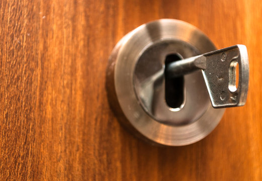 Closeup image of lock and key.  Home door with lock and key