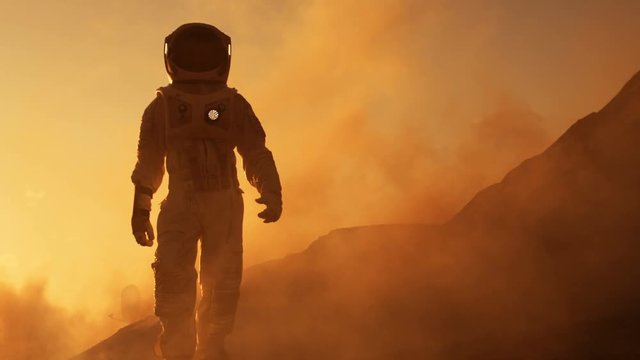 Proud Astronaut Confidently Walks on Mars Surface. Red Planet Covered in Gas and rock,  Overcoming Difficulties, Important Moment for the Human Race. Shot on RED EPIC-W 8K Helium Cinema Camera.