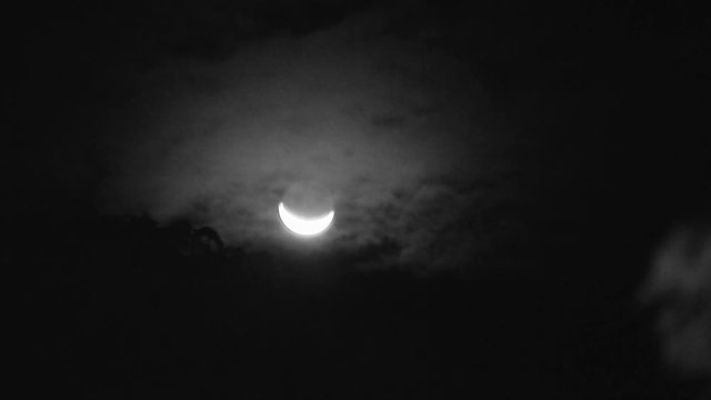 A steady zoomed in shot in monochromatic shot of the shining moon.
