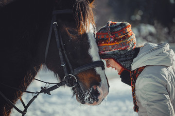 Winter portrait of teen girl with horse