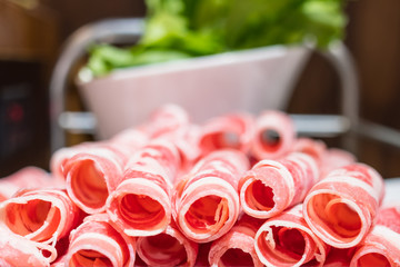 A plate of raw meat in a chinese hot pot restaurant