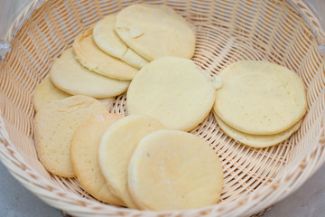 The small cooked pizza bread in basket.