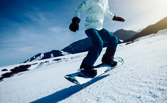 one snowboard snowboarding on slope in ski resort