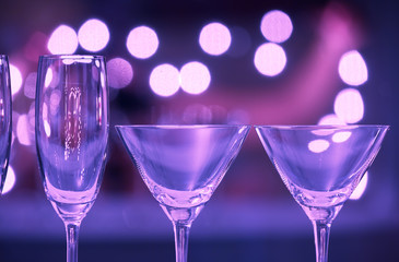 closeup of martini, champaign glasses on a bar counter. 