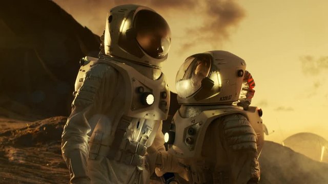 Two Astronauts Talking while Exploring Mars/ Red Planet. Space Exploration, Adventure and Colonisation Theme. Shot on RED EPIC-W 8K Helium Cinema Camera.