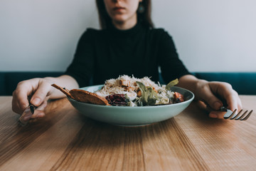 Flatlay salad with girl hands, knife and fork