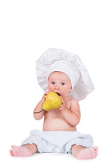 Cheerful little child with a pear in his hands in a chef suit on a white background.