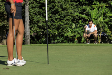 Couple playing golf on a golf course