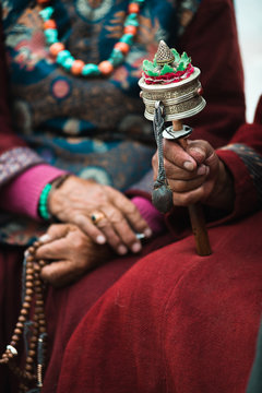 Traditional tibetian man holding prayer wheel. Ladakh. India