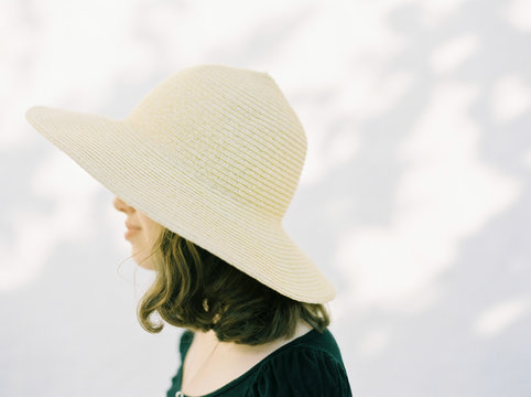 Close up of profile of girl wearing hat