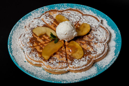 Chopped caramelized apples for breakfast on a black background
